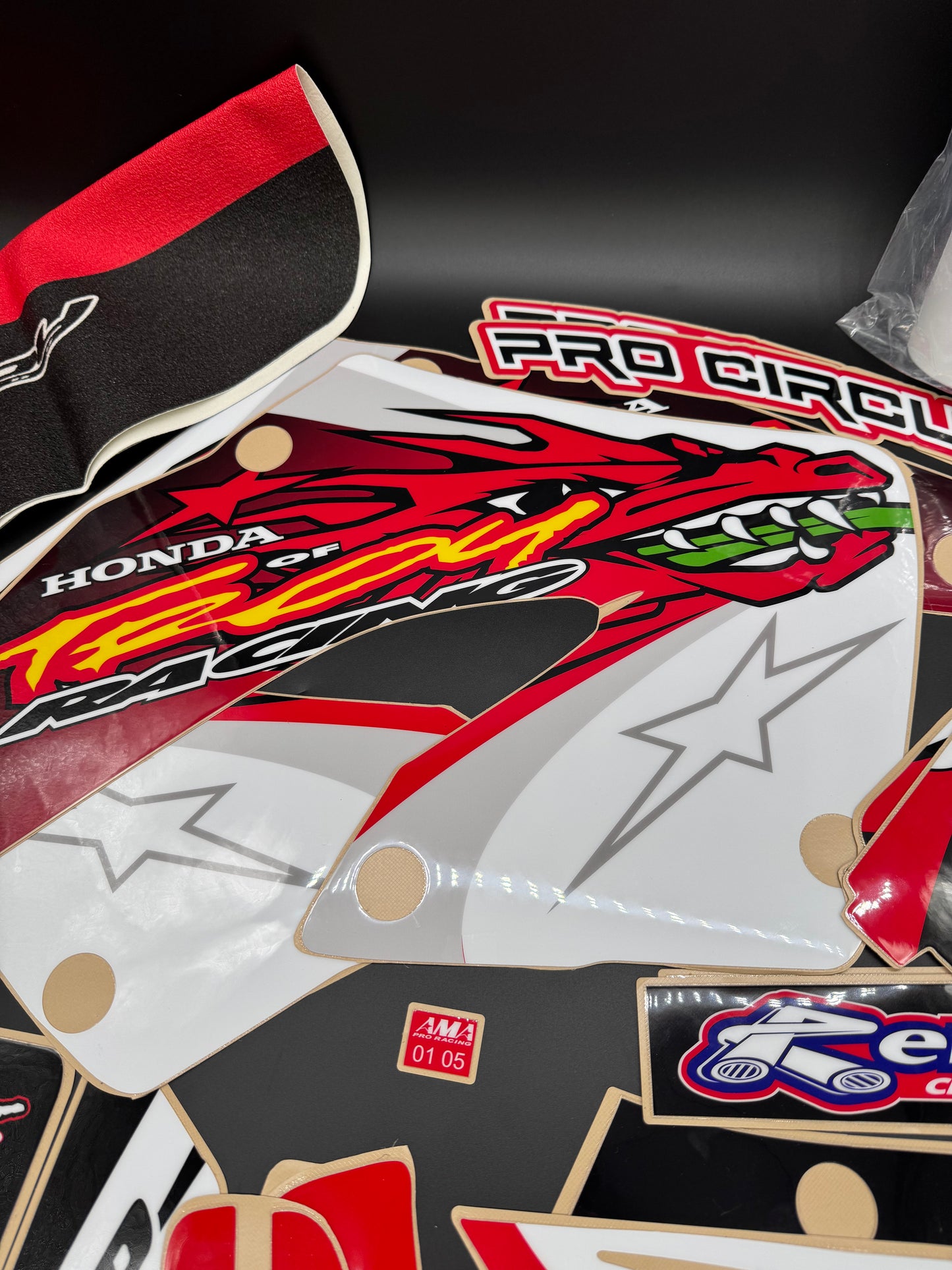 Close-up of a motorcycle fairing with branding and graphics on a dark background