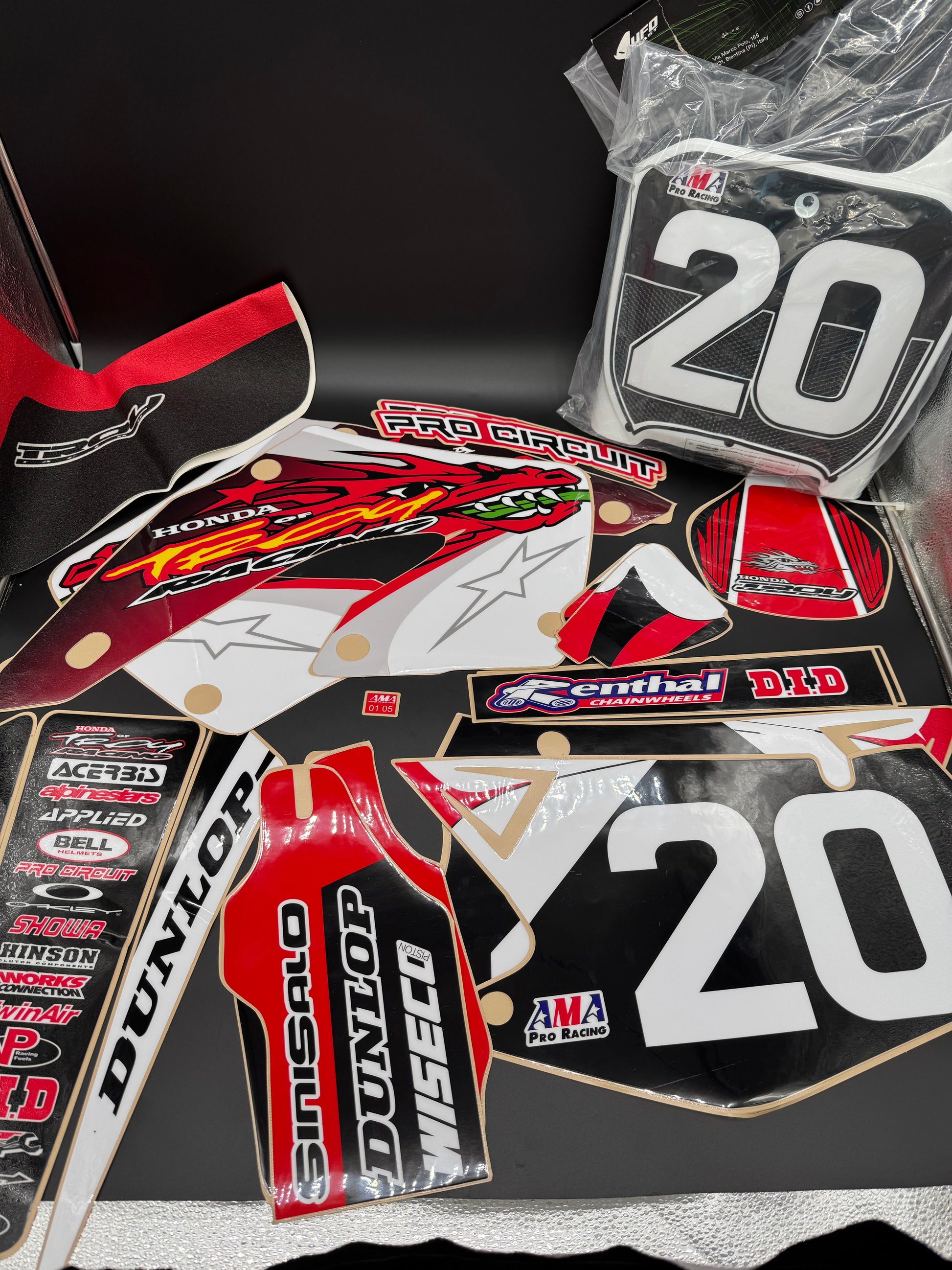 Collection of motorcycle decals with various brand logos on a black background