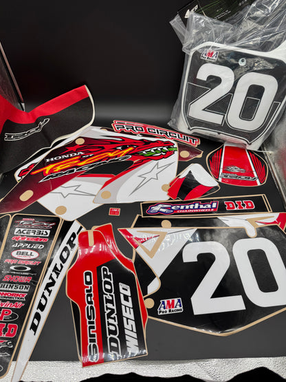 Collection of motorcycle decals with various brand logos on a black background